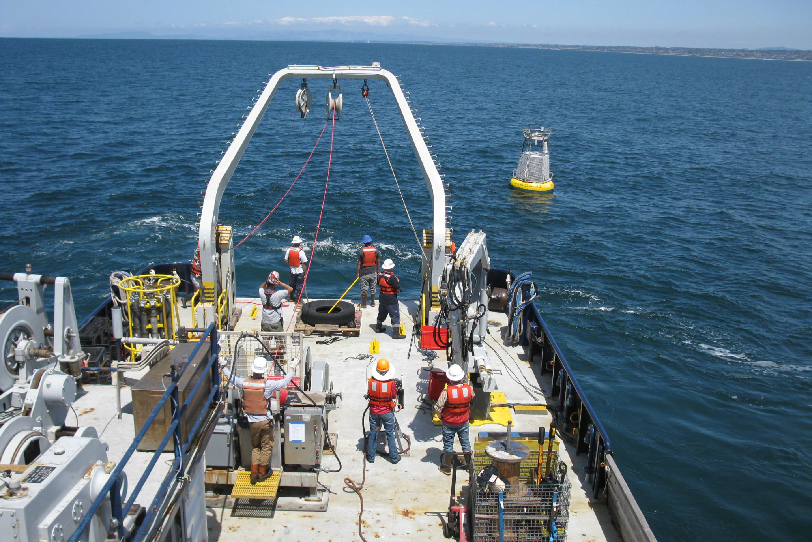 A crew of engineers, scientists, and students prepare to recover the Del Mar mooring in 2017 for routine maintenance