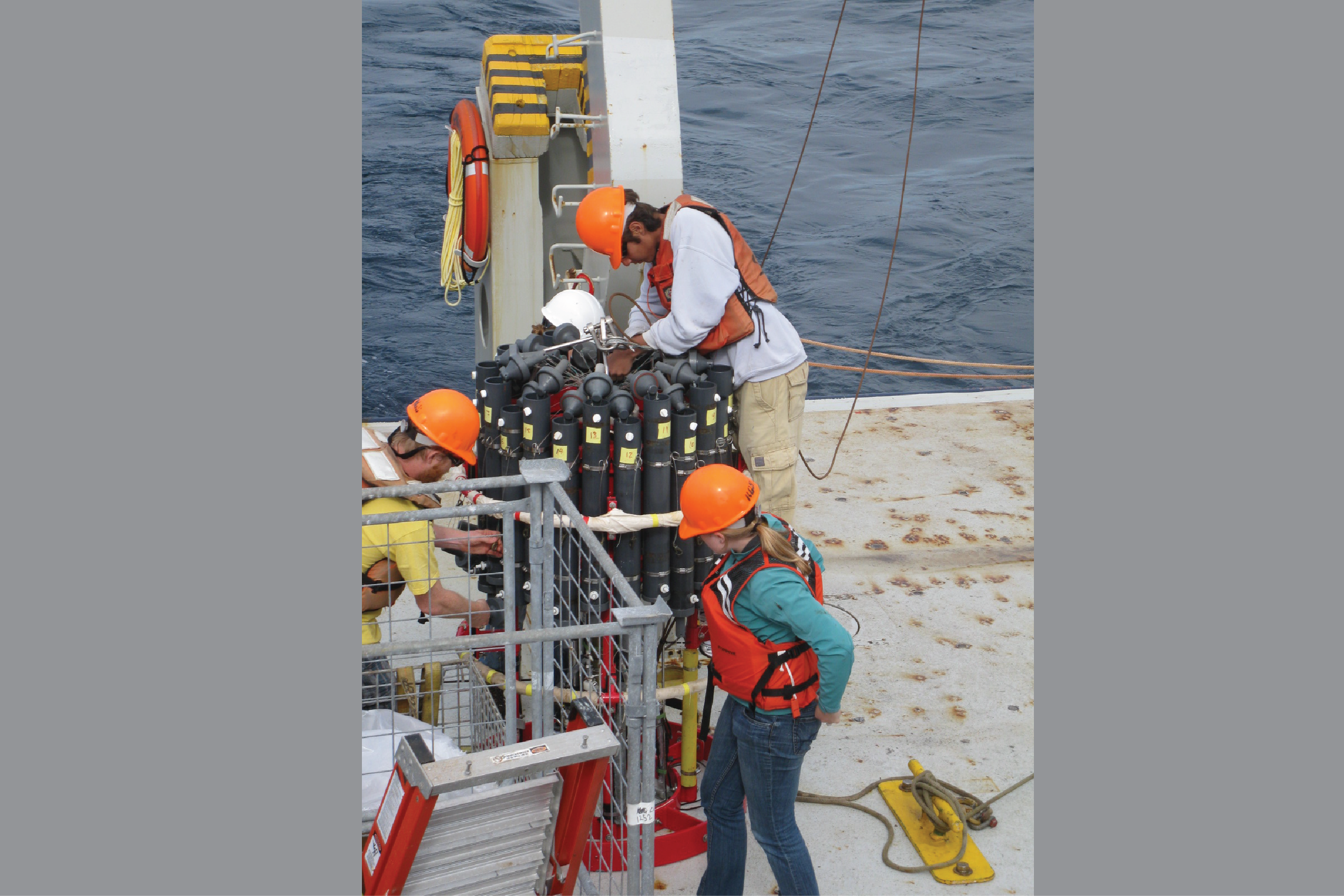 Graduate students prepare the CTD rosette for bottle samples collected near the Del Mar mooring, for calibration and validation of the moored sensors, 2011